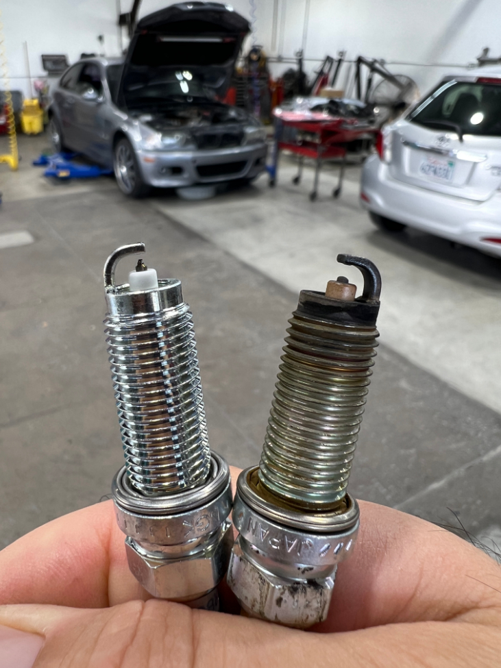New spark plug compared to worn spark plug removed from customer vehicle at Hyarcs Auto Repair in Pasadena CA